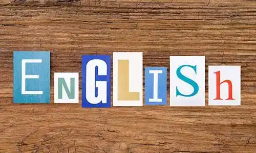 © photka - stock.adobe.com | Word "English" in cut out magazine letters on wooden background
