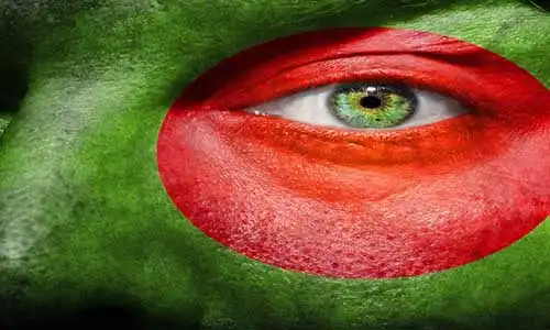© semmickphoto - Fotolia | Flag painted on face with green eye to show Bangladesh support