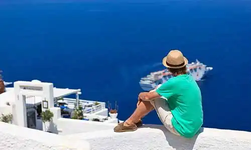 © nadezhda1906 - Fotolia | tourist looking at the sea in Santorini
