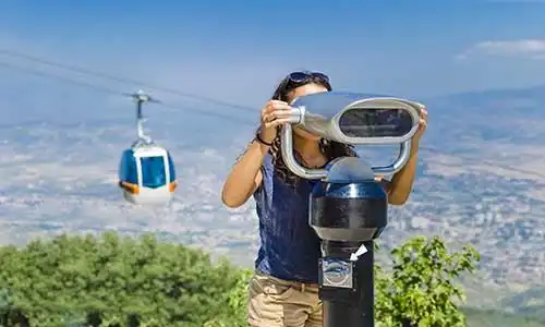 © zefart - Fotolia | Beautiful girl is looking at coin operated binocular
